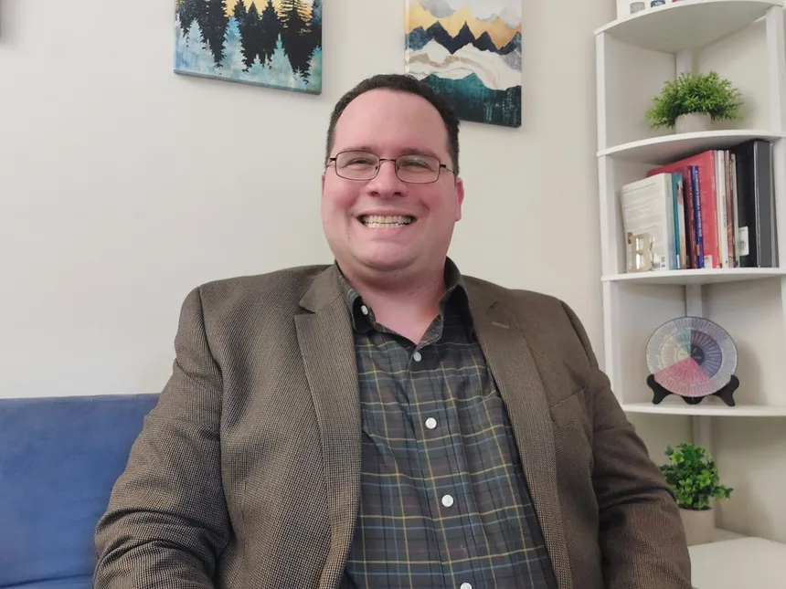 Greg Bing seated in his office, the space he works from for telehealth sessions across New Jersey