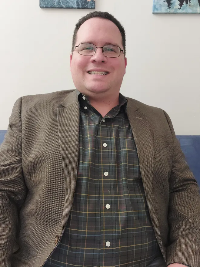 Greg Bing, Licensed Professional Counselor, smiling warmly in his office