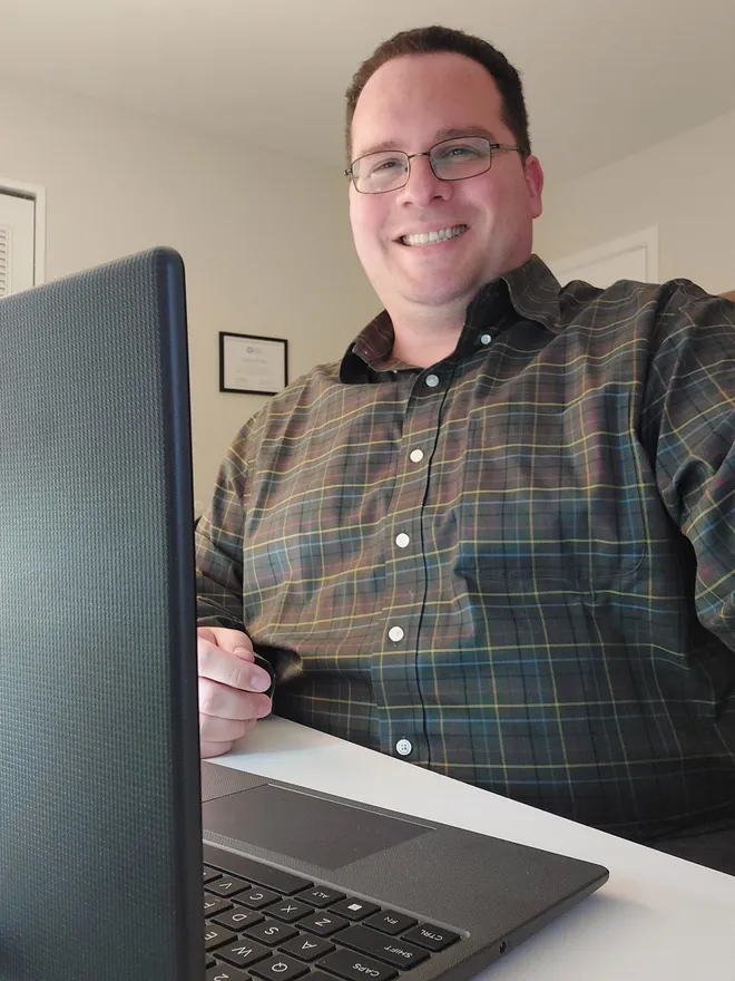Greg Bing at his laptop, set up for a telehealth counseling session